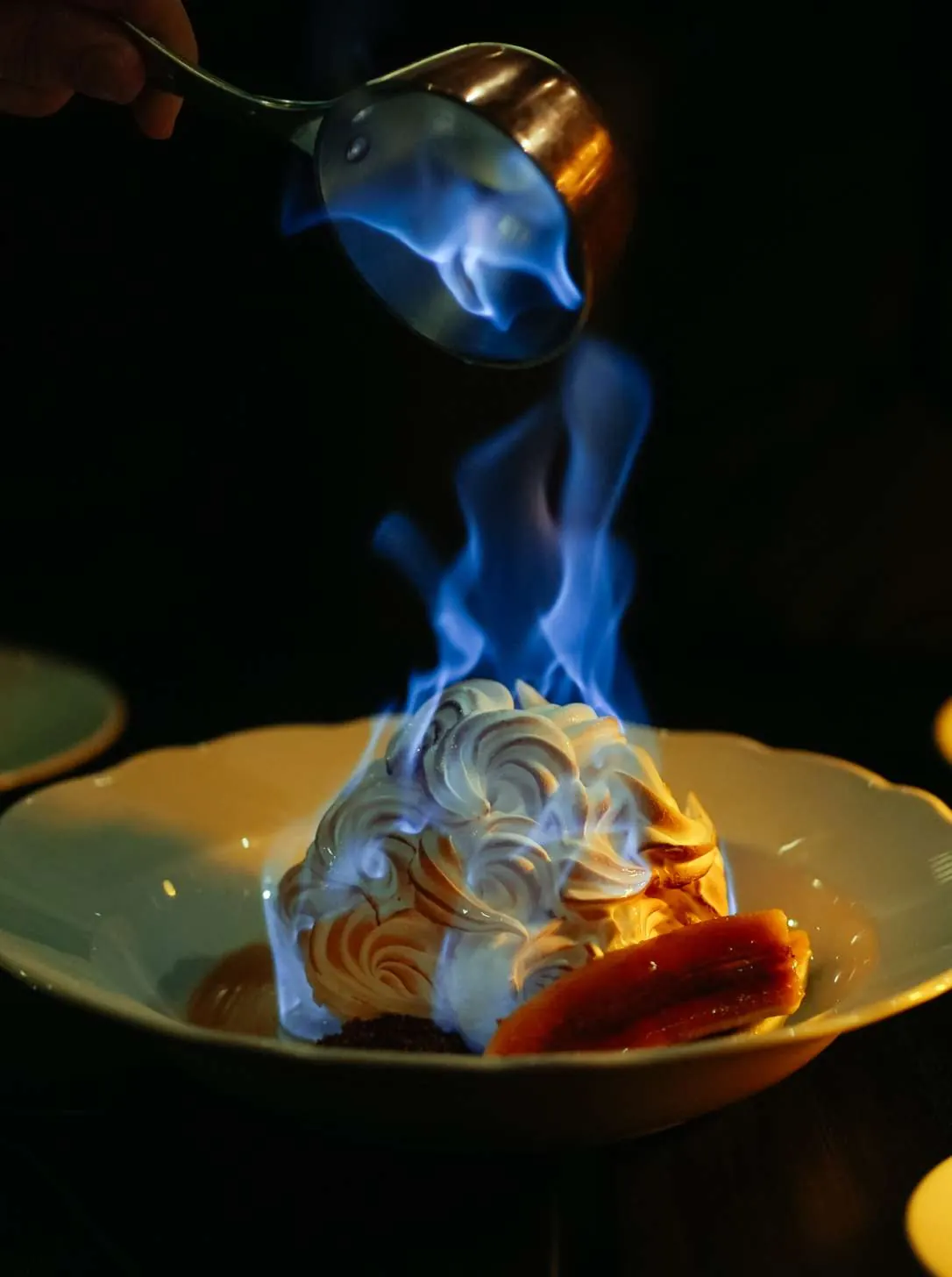 Bananas Foster Baked Alaska being flambéed