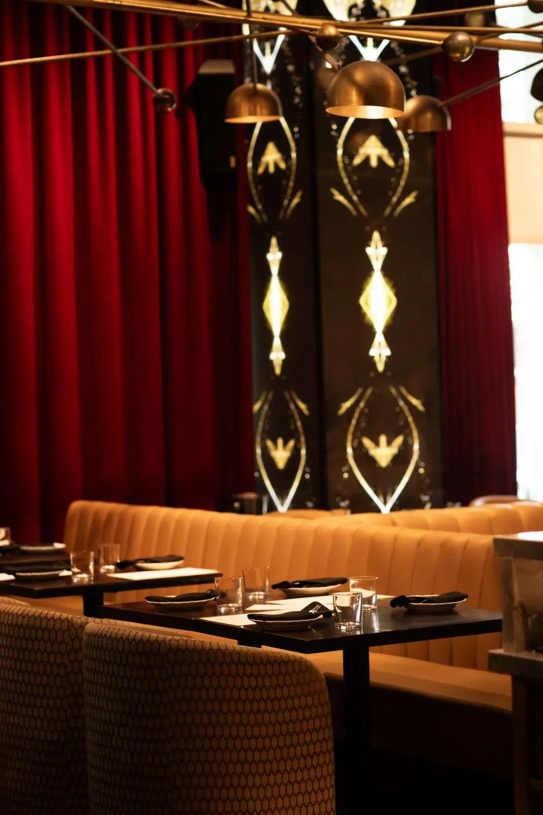 Velvet banquettes and art deco pillars in the dining room