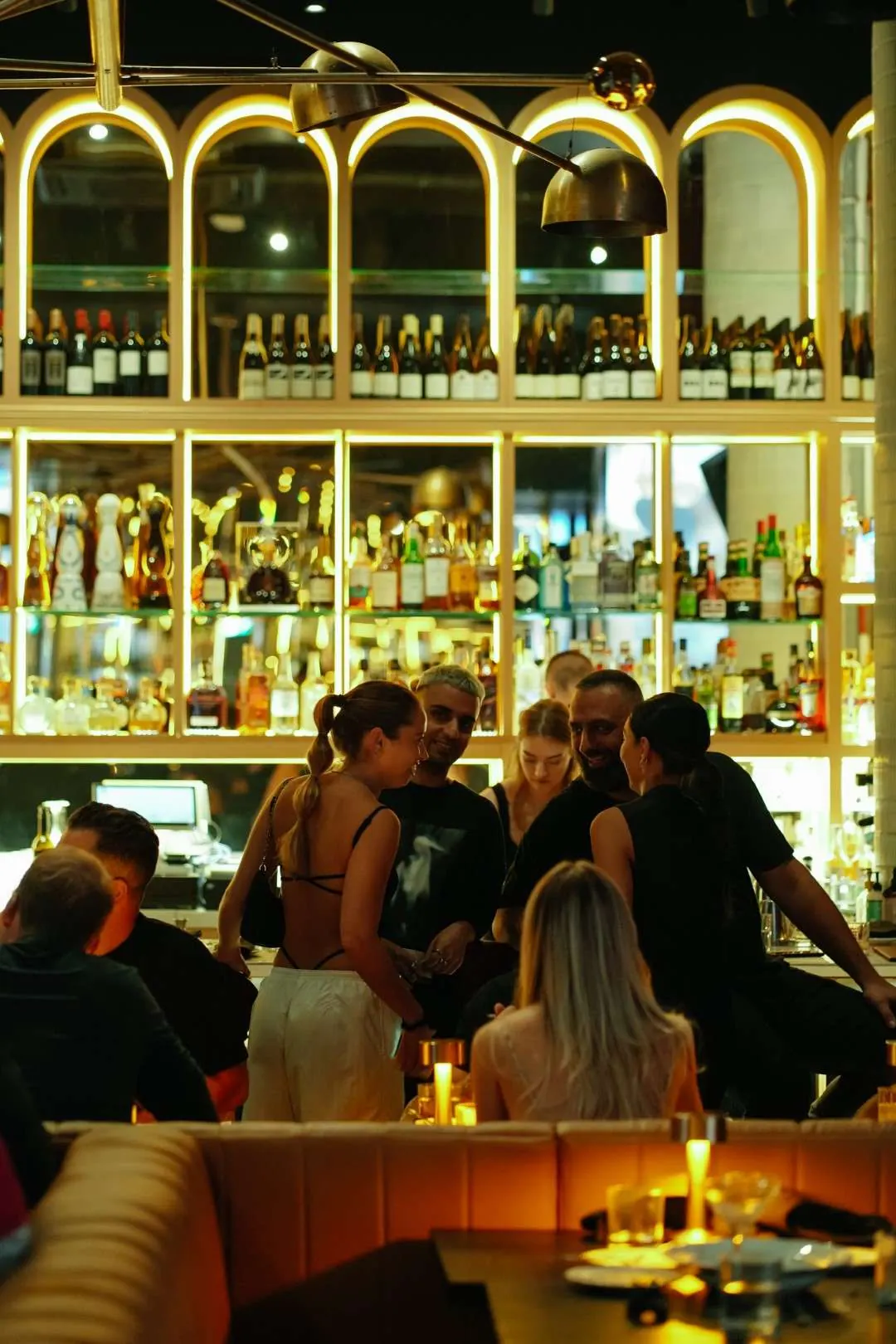 Guests gathering at the bar on a busy night