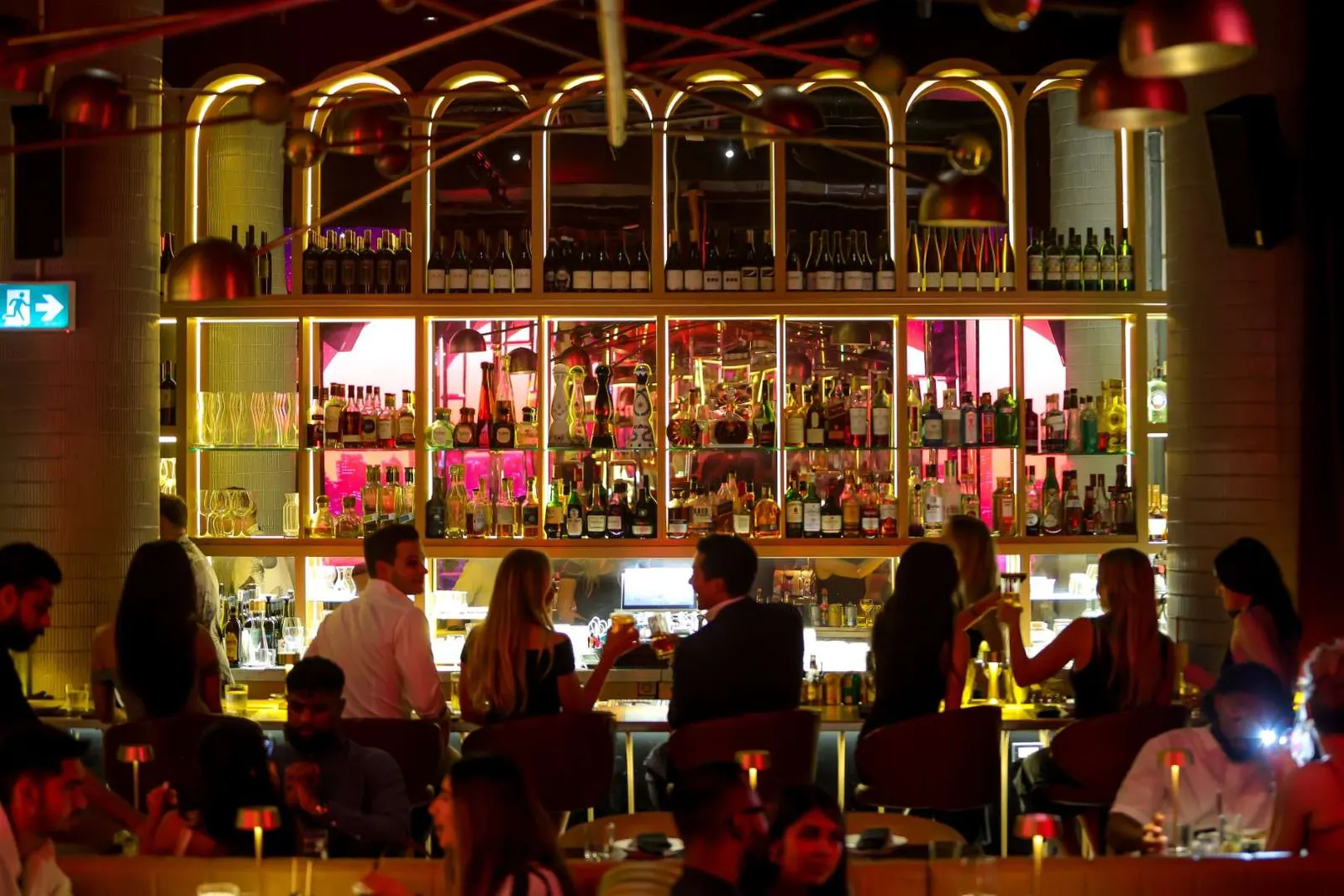 The gold-lit arched bar and dining room at Maxime’s King West
