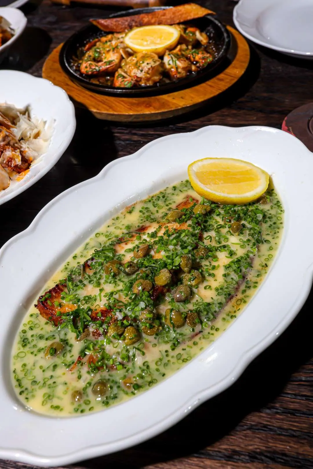 Whole fish in herb butter with lemon at Maxime’s